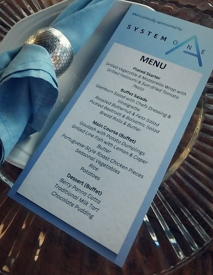 A printed menu card set on a charger plate at the gala dinner